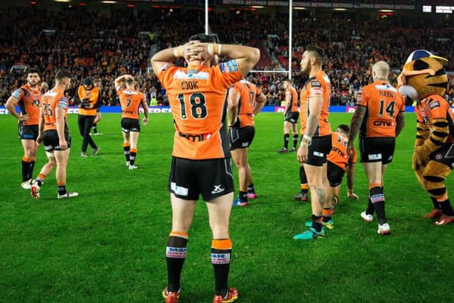 Castleford Tigers players dejected after defeat in last year's Grand Final. Picture: Alex Whitehead/SWpix.com
