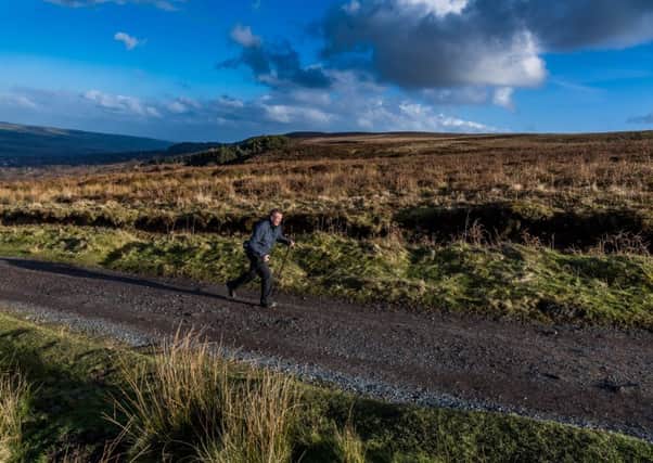 A man, nordic walking along an old Roman road that crosses Rombalds Moor in Ilkley. 
Picture by James Hardisty.