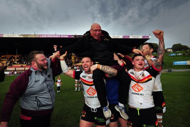 John Kear is lifted up by his players. Picture by Simon Hulme