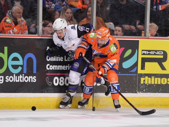 STRUGGLE: Sheffield Steelers' Evan McGrath battles on the boards during Sunday night's 4-2 defeat at home to Glasgow Clan. Picture: Dean Woolley.