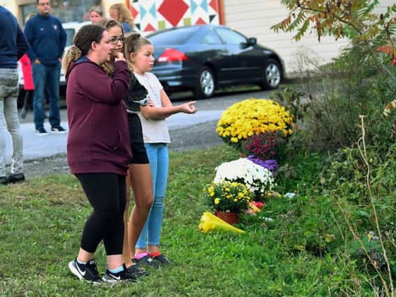 A limousine loaded with revelers headed to a 30th birthday party blew a stop sign at the end of a highway and slammed into an SUV parked outside a store, killing all people in the limo and a few pedestrians, officials and relatives of the victims said Sunday. (AP Photo/Hans Pennink)
