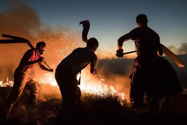 Firefighters tackling a blaze on Saddleworth Moor earlier this summer.