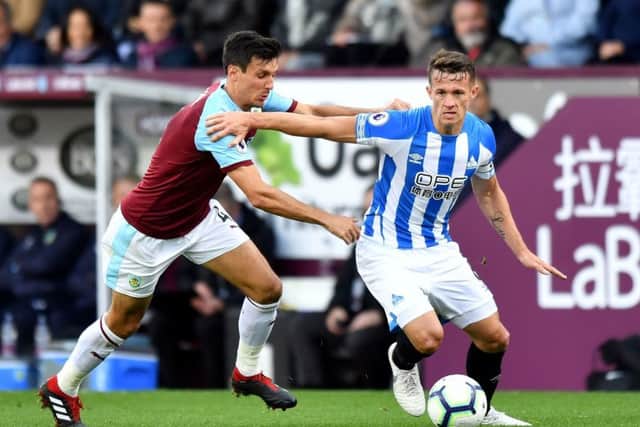 Huddersfield Town's Jonathan Hogg (right) and Burnley's Jack Cork battle for the ball at Turf Moor. Picture: Anthony Devlin/PA
