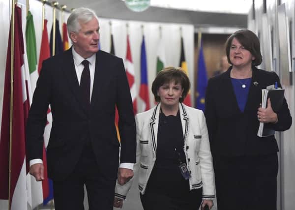 European Union chief Brexit negotiator Michel Barnier, left, arrives with Northern Ireland Democratic Unionist Party leader Arlene Foster, right, and DUP European Parliament member Diane Dodds for their meeting at the European Commission headquarters in Brussels.