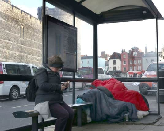 A rough sleeper in a bus stop in Windsor. Rough sleepers are being advised to consider avoiding parts of Windsor town centre when Princess Eugenie marries Jack Brooksbank.