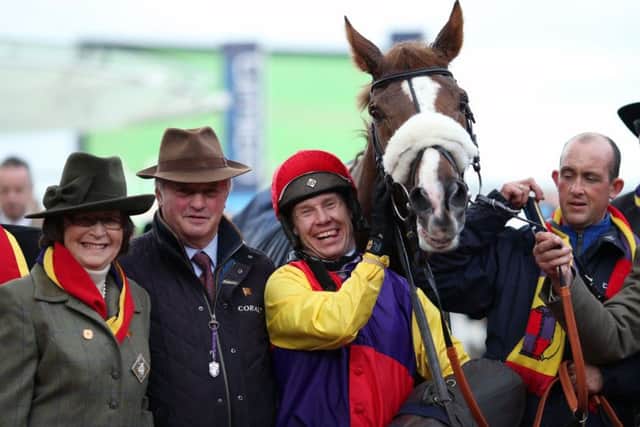 Jockey Richard Johnson (centre) and trainer Colin Tizzard (centre left) celebrate winning the Timico Cheltenham Gold Cup Chase with Native River.