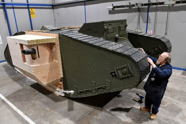 Geoff Armstrong with his life size model of a British WW1 era tank. Picture: SWNS