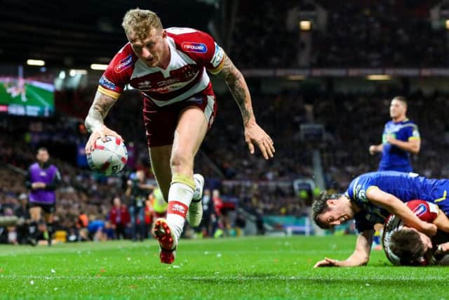 Wigan's Dom Manfredi goes over their first try (Alex Whitehead/SWpix.com)