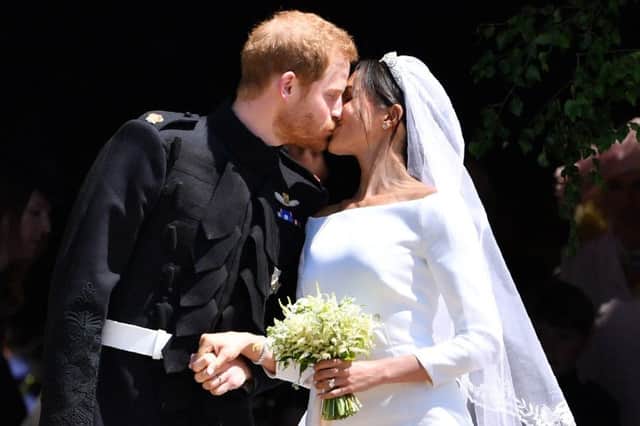 Prince Harry and Meghan Markle kiss as they leave at St. George's Chapel in Windsor Castle after their wedding ceremony.