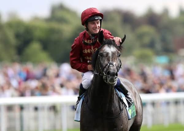 Oisin Murphy and Roaring Lion celebrate the horse's win in the Juddmonte International at York.