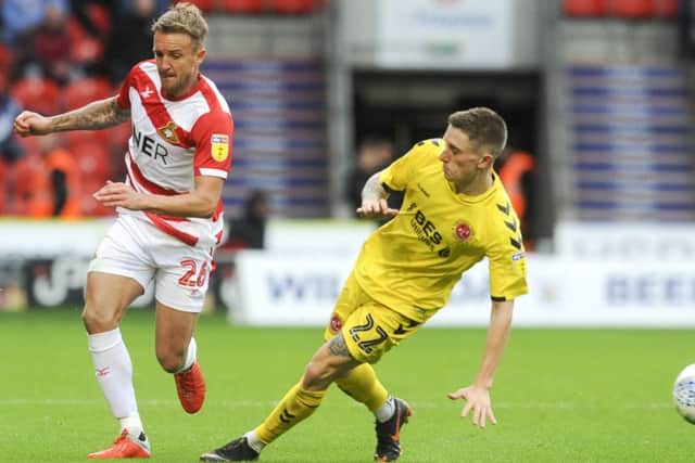 Doncaster Rovers's James Coppinger beats Ashley Hunter of Fleetwood Town (Picture: Dean Atkins)