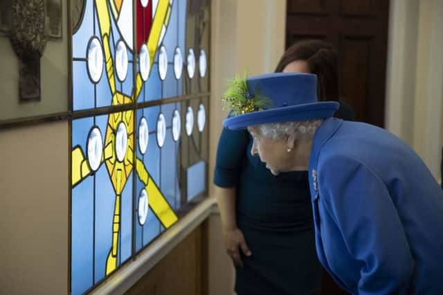 The Queen being shown the new stained-glass window during her visit to the Royal Air Force Club in London to mark its centenary year.
