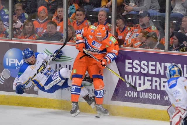 Tanner Eberle gets a hit in on a Fife opponent at Sheffield Arena. Picture: Dean Woolley.