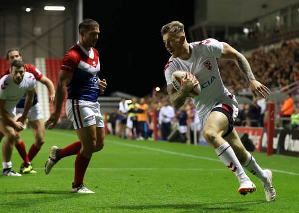 Crossing: England's Tom Johnstone goes over for a try against France.