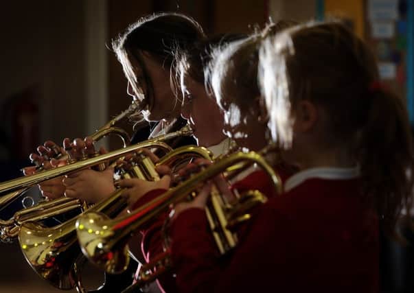 The brass band at Foxhill Primary School where pupils perform outside the local supermarket to raise funds for music education.