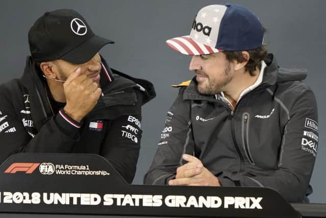 Mercedes driver Lewis Hamilton, left, of Britain, talks with McLaren driver Fernando Alonso. (AP Photo/Darren Abate)