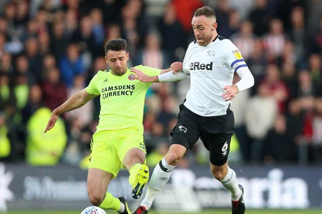 Derby County's Richard Keogh (right) and Sheffield United's Enda Stevens battle for the ball during the Sky Bet Championship match at Pride Park, Derby CREDIT: Nigel French/PA Wire