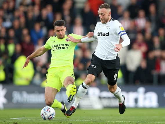 Derby County's Richard Keogh (right) and Sheffield United's Enda Stevens battle for the ball during the Sky Bet Championship match at Pride Park, Derby CREDIT: Nigel French/PA Wire