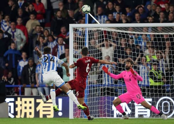Miss: Huddersfield Town's Steve Mounie shoots over the crossbar late on against Liverpool.