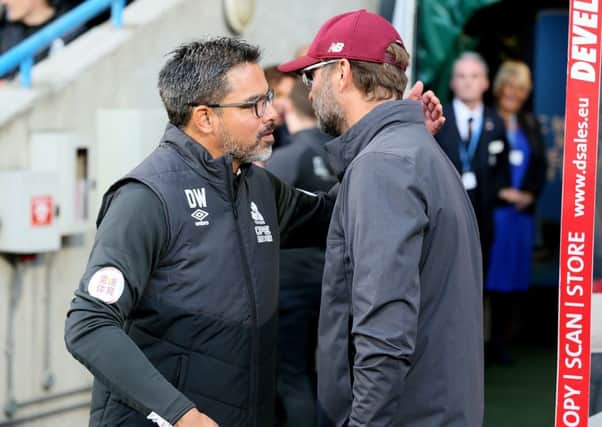 FRIENDS: Huddersfield Town manager David Wagner (left) and Liverpool manager Jurgen Klopp greet each other at the John Smith's Stadium. Picture: Richard Sellers/PA.