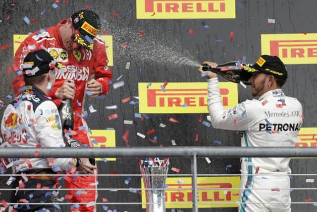 LONG TIME COMING: Ferraris Kimi Raikkonen celebrates his victory with Lewis Hamilton and Max Verstappen at the Circuit of the Americas, Austin. Picture: AP Photo/Darron Cummings