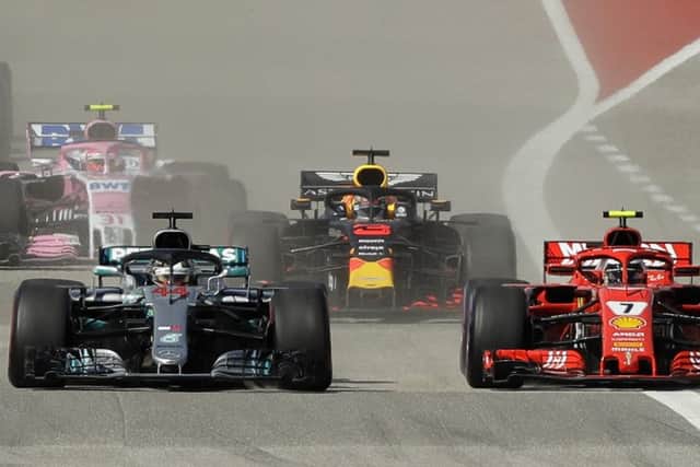 LEADING ROLE: Ferrari driver Kimi Raikkonen, right, passes Mercedes driver Lewis Hamilton  in Austin. Picture: AP/Eric Gay.