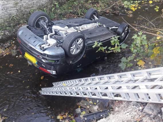 The car plunged 10ft and landed on its roof. Photo: North Yorkshire Fire and Rescue Service