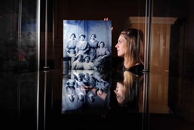 Vicky Siviter with one of the old photographs. Picture by Simon Hulme