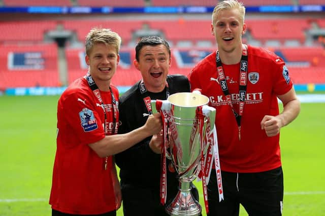 HAPPY DAYS: Paul Heckingbottom celebrates winning the League One play-off final trophy with Barnsley's Lloyd Isgrove and Marc Roberts at Wembley. Picture: Nigel French/PA