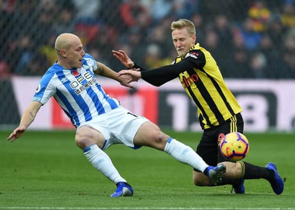 Huddersfield Town's Aaron Mooy and Watford's Will Hughes battle for the ball.