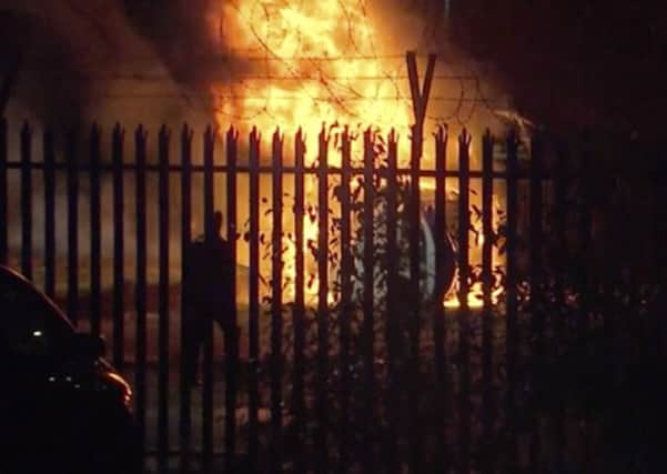 This image from video shows a burning helicopter in a parking lot outside the King Power Stadium in Leicester.