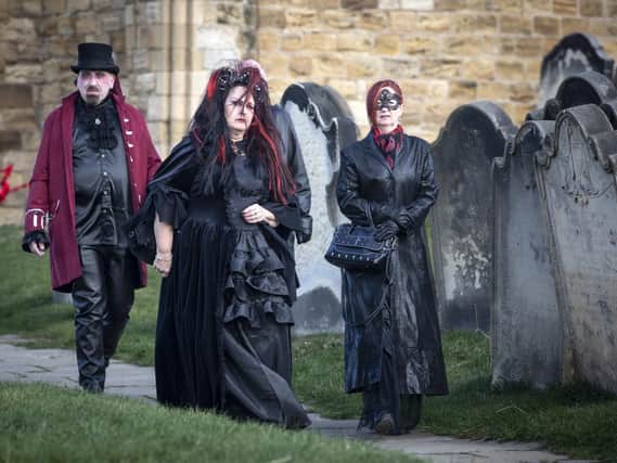 Goths walk past tombstones