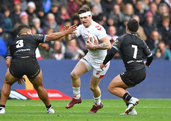 England's John Bateman tries to break through the New Zealand line at The KCOM Stadium. Picture: Dave Howarth/PA