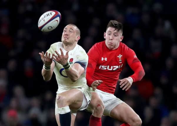 England's Mike Brown gathers the ball ahead of Wales' Josh Adams during February's Six Nations match at Twickenham (Picture: Adam Davy/PA Wire).