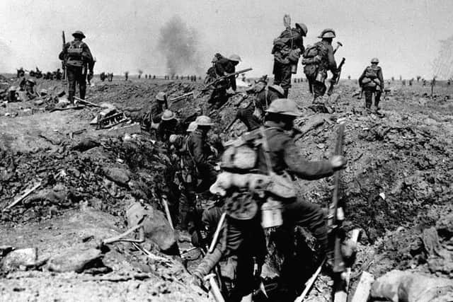 British troops negotiate a trench as they go forward in support of an attack on the village of Morval during the Battle of the Somme. A shell can be seen exploding in the distance. 
Picture part of PA First World War collection.