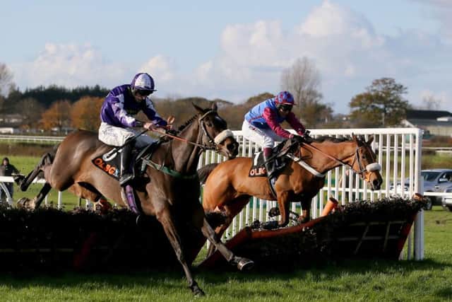 Lady Buttons and Adam Nicol, nearside, bid to win the Mares' Hurdle at Wetherby today.