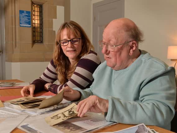 Michael Hassell and Professor Alison Fell look through information about Michae's grandfather Cyrille Desaeger.