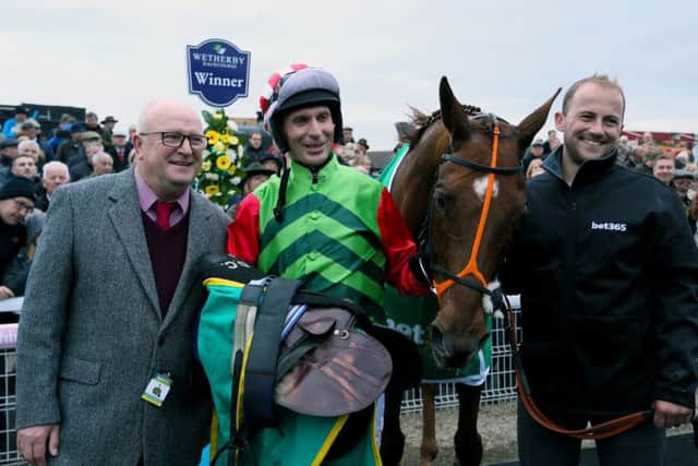 owner Phil Martin (left) and jockey Danny Cook celebrate Definitly Red's win.