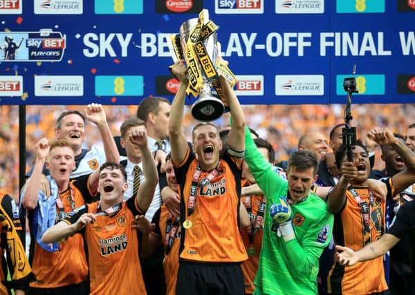 Hull City's Michael Dawson lifts the trophy after winning the Championship Play-Off Final at Wembley Stadium in May 2016. Picture: Nigel French/PA
