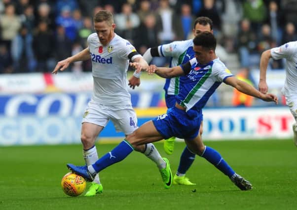 Leeds United's Adam Forshaw is challenged by Antonee Robinson of Wigan Athletic. (Picture: Simon Hulme)