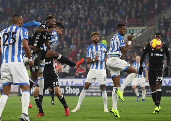 Huddersfield Town's Christopher Schindler gets a header in on goal. Picture: Martin Rickett/PA