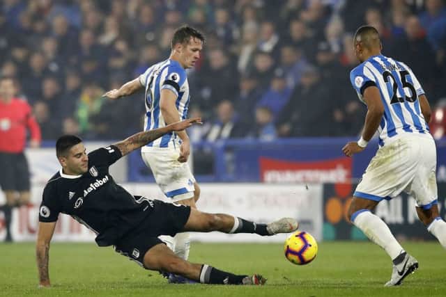 Fulham's Aleksandar Mitrovic (left) and Huddersfield Town's Jonathan Hogg battle for the ball (Picture: Martin Rickett/PA Wire)