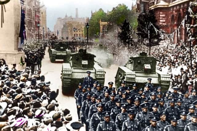 A coloured version of a photo showing the parade down Whitehall following the end of the First World War.