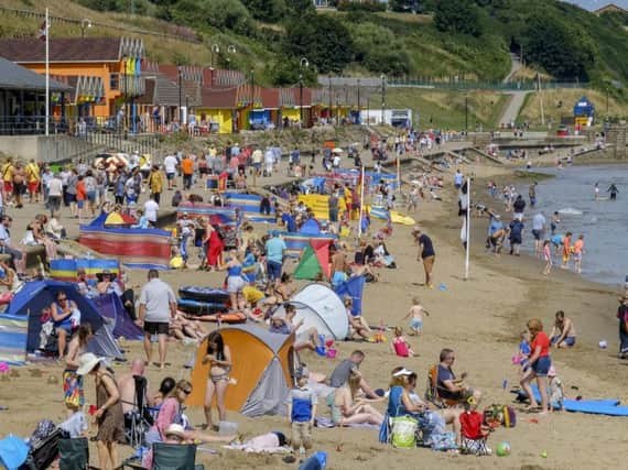 Scarborough's North Bay on a busy weekend at the Yorkshire coast in August as people headed for the beach for sea breezes and a paddle to keep them cool.