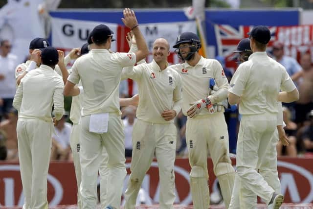England's Jack Leach, center, celebrates the dismissal of Sri Lanka's Kusal Mendis in Galle. Picture: AP/Eranga Jayawardena.