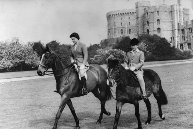 The Queen and Prince Charles, out riding at Windsor Castle in 1961