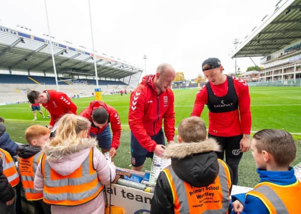 GROWING APPEAL: England's RL players players sign autographs and meet local schoolchildren at Headingley before practice on Wednesday. Picture: Allan McKenzie/SWpix.com