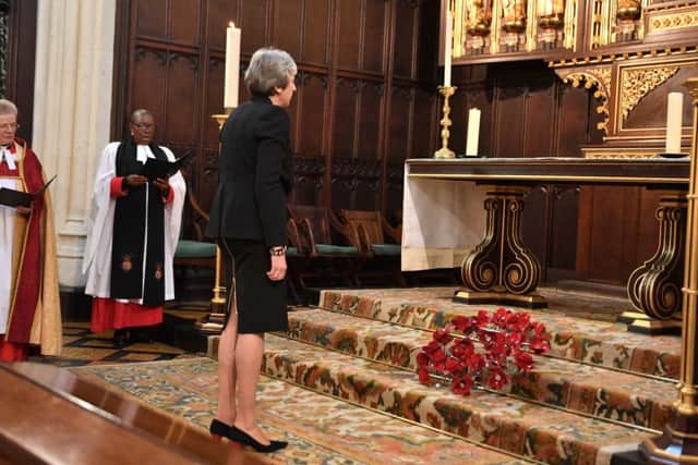 Theresa May will visit war cemeteries in Britian and France today. She is pictured taking part in Parliament's service of remembrance earlier this week.