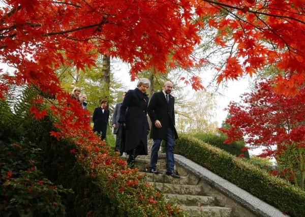 Prime Minister Theresa May (left) walks at the St Symphorien Military Cemetery in Mons, Belgium, with Belgian Prime Minister Charles Michel. PRESS ASSOCIATION Photo. Picture date: Friday November 9, 2018. During her visit she laid a wreath at the graves of John Parr, the first UK soldier to be killed in 1914, and George Ellison, the last to be killed before Armistice.