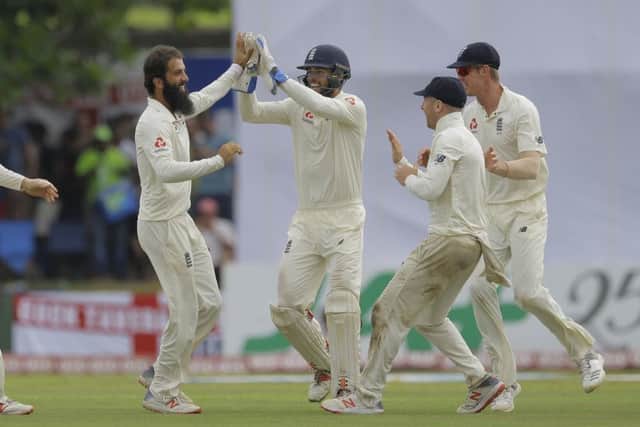 England's Moeen Ali, second left, celebrates the dismissal of Sri Lanka's Niroshan Dickwella with team mates in Galle. Picture: AP Photo/Eranga Jayawardena